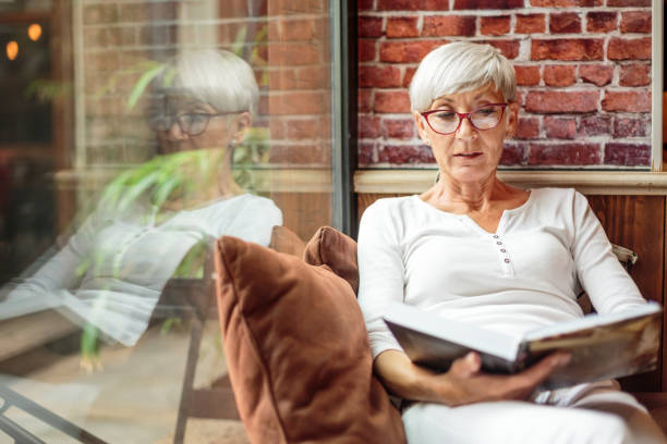 istock Senior woman reading a book 1030871394