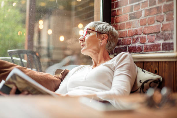 istock Senior woman holding a book 1030871556