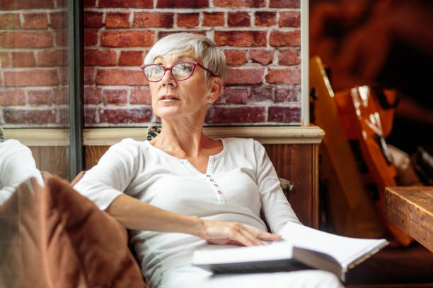 istock Senior woman holding a book 1030871644