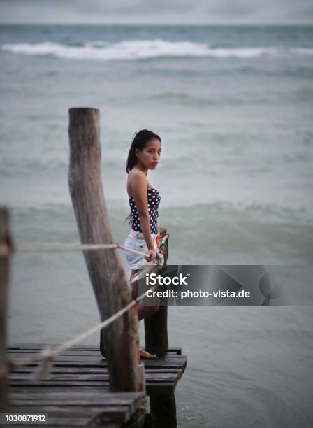 Girl On A Catwalk In Stormy Weather Stock Photo - Download Image Now - Adult, Adults Only, Beach