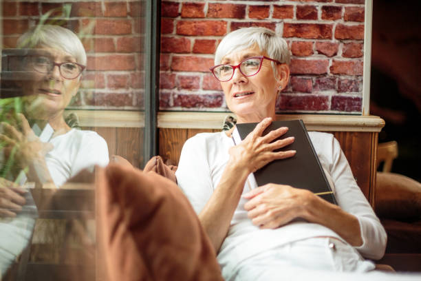 istock Senior woman holding a book 1030872960