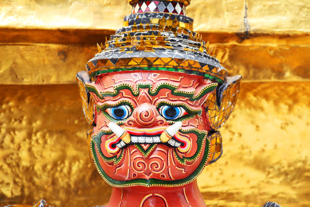 istock tradition demon mask statue with royal palace golden chedi wall background 1030874982