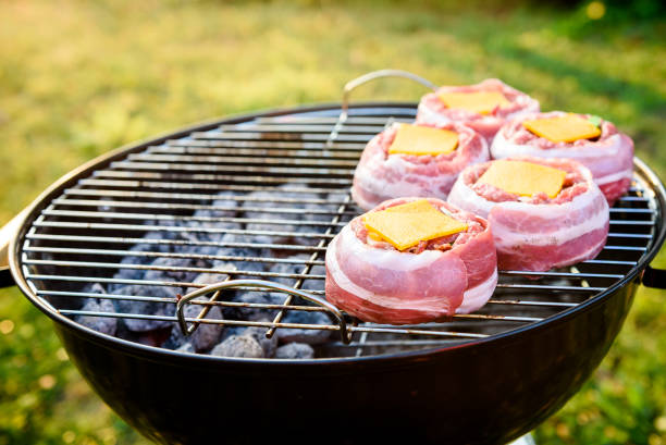 istock Making home made Beer Can Bacon Burgers on barbecue grill. 1030878766