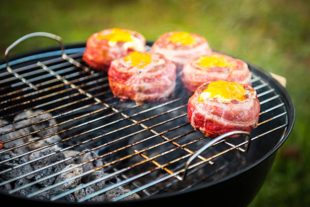 istock Making home made Beer Can Bacon Burgers on barbecue grill. 1030879062