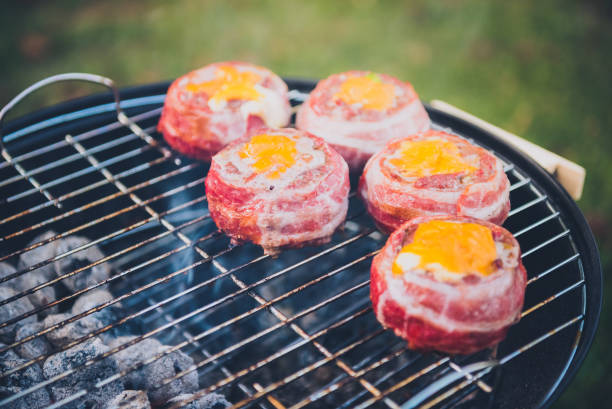 istock Making home made Beer Can Bacon Burgers on barbecue grill. 1030879100