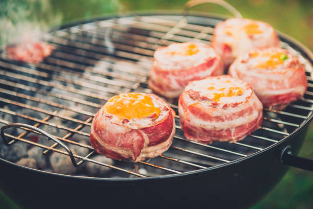 istock Making home made Beer Can Bacon Burgers on barbecue grill. 1030879110