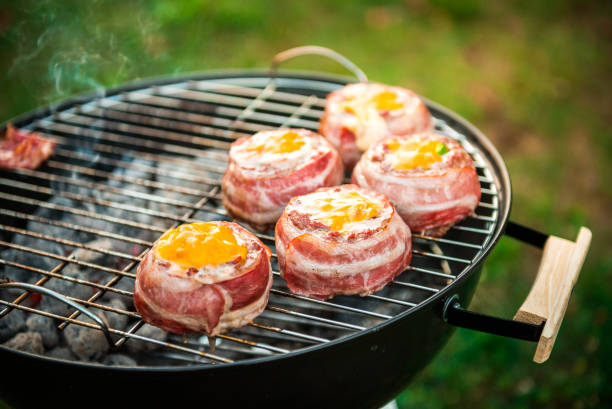 istock Making home made Beer Can Bacon Burgers on barbecue grill. 1030879122