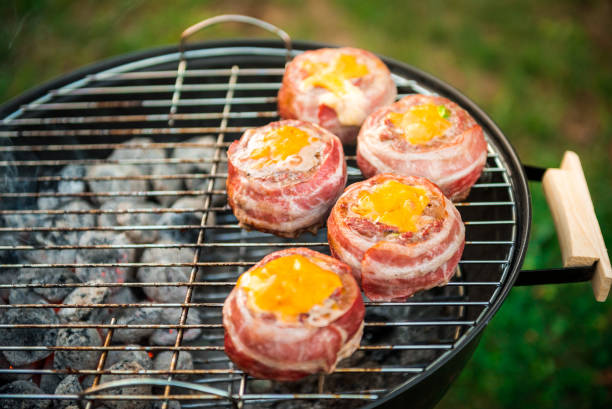 istock Making home made Beer Can Bacon Burgers on barbecue grill. 1030879142