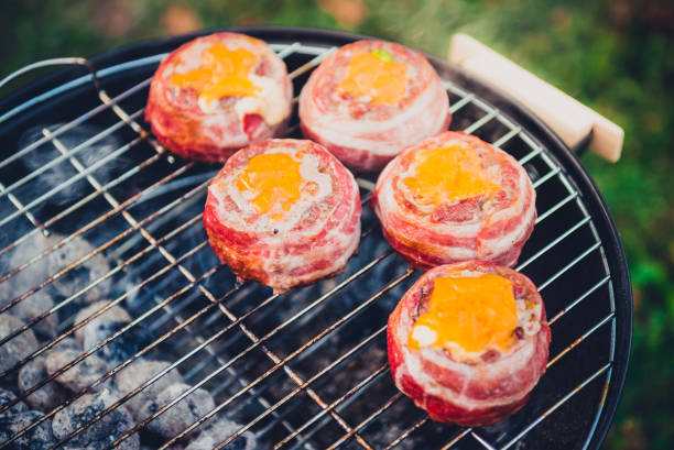 istock Making home made Beer Can Bacon Burgers on barbecue grill. 1030879174