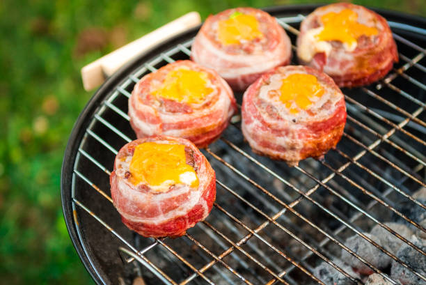 istock Making home made Beer Can Bacon Burgers on barbecue grill. 1030879182
