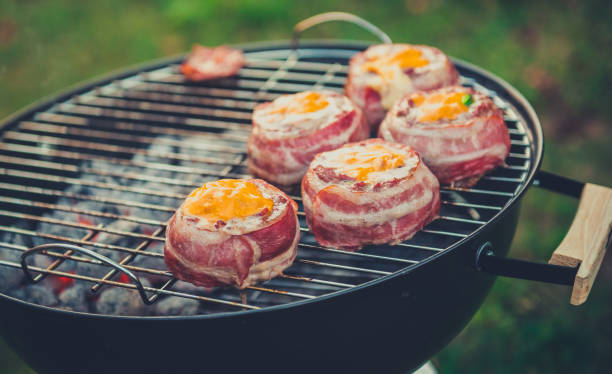istock Making home made Beer Can Bacon Burgers on barbecue grill. 1030879236
