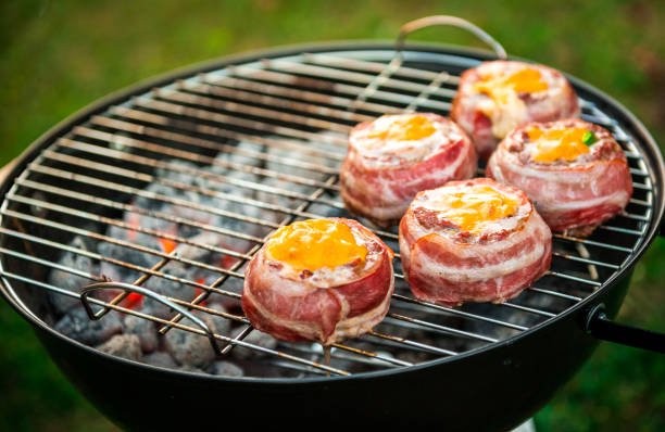 istock Making home made Beer Can Bacon Burgers on barbecue grill. 1030879264