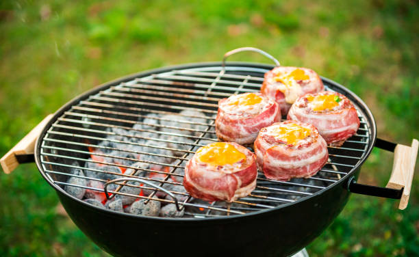 istock Making home made Beer Can Bacon Burgers on barbecue grill. 1030879294
