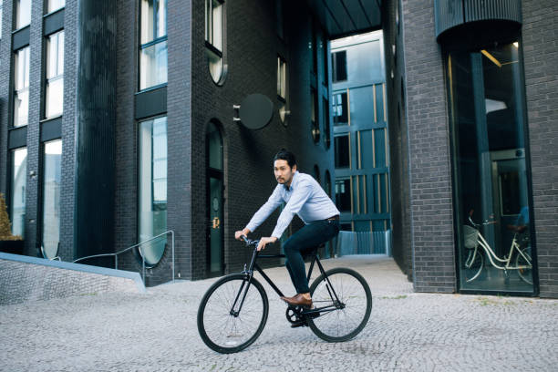 istock Businessman riding with bicycle 1030882856