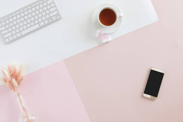 istock Female desk and stationery on pastel colored background. Flat lay, top view. Workspace with laptop, copy space 1030883502