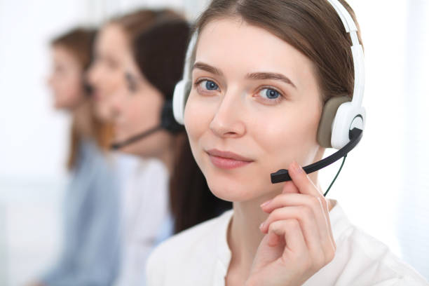 istock Call center. Beautiful cheerful smiling operator consulting clients with headset. Business concept of customer service. 1030887508