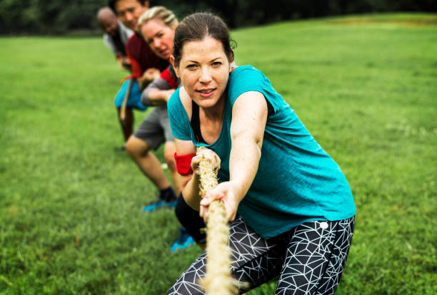 istock Team competing in tug of war 1030887542