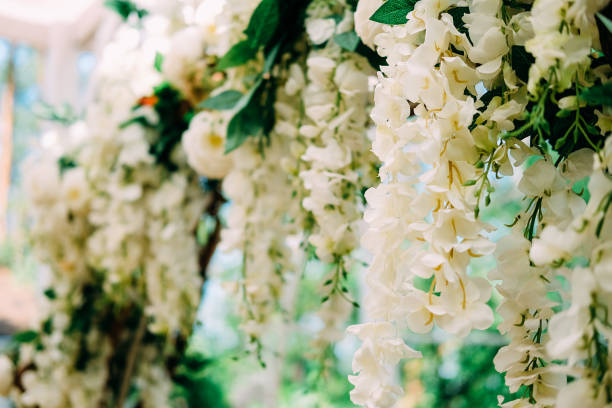 istock Getting ready for the wedding ceremony. Wedding arch decorated with white flowers 1030887822