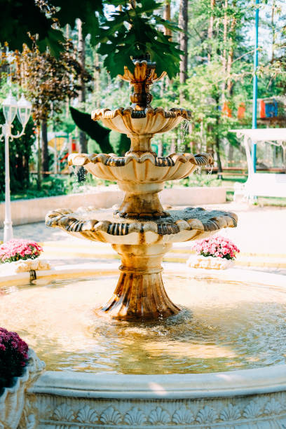 istock Nice cozy European yard with bench and small fountain 1030887912