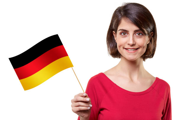 Young woman holding a German flag on white background