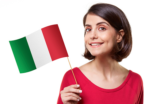 Young woman holding a Italian flag on white background