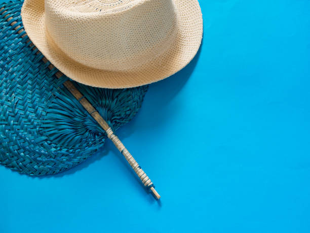 istock Fan and hat on blue background with copy space 1030892264