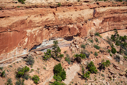Erosion, freeze-thaw cycle causes rock sloughs off the face of rock strata seen in Canyonlands National Park