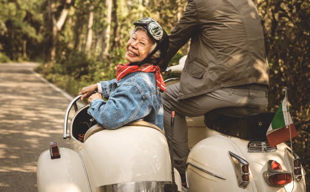 istock An elderly couple is riding a classic scooter 1030892664