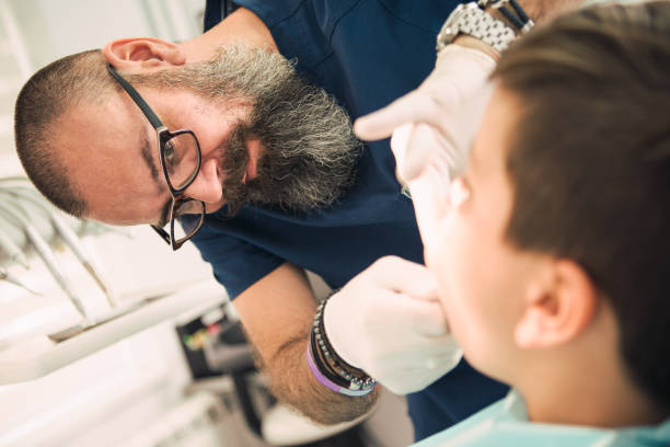 istock Pediatric dentistry. Dentist examining a young boy 1030896646