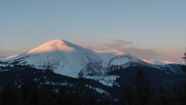 istock Winter landscape with mountain range at sunrise. Blue sky over the mountain range in winter 1030897126