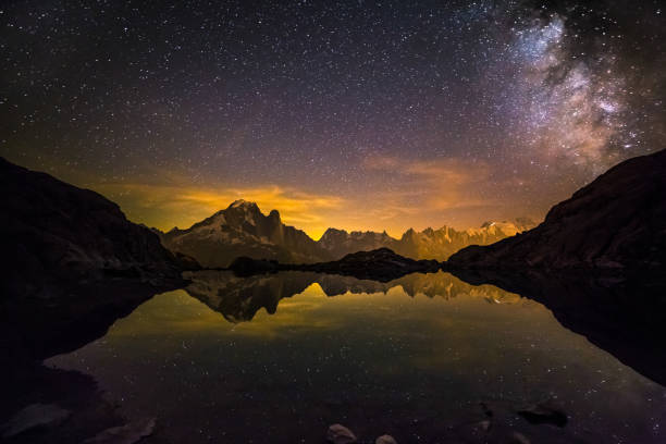 milky way and starry sky over iconic snowy mont-blanc peaks reflecting in altitude lake - eternity spirituality landscape rock imagens e fotografias de stock