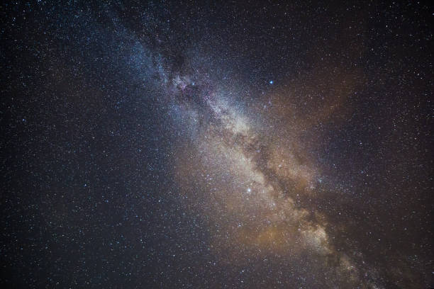 istock Milky Way and Starry Sky on a Clear Summer Night with a Cloud 1030899780