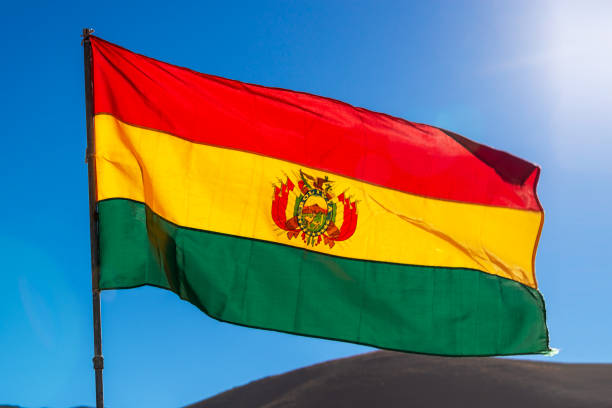 istock Bolivian flag, blue sky background 1030901940