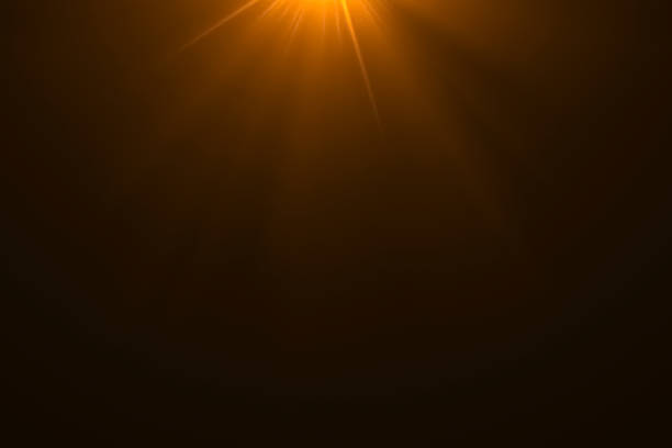 istock gold warm color bright lens flare rays light flashes leak movement for transitions on black background,movie titles 1030901982