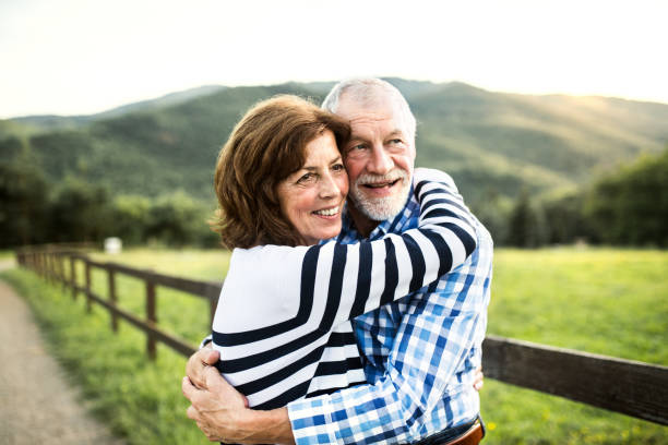 istock A senior couple hugging outdoors in nature. 1030906606