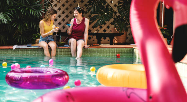 istock Girls relaxing by the swimming pool 1030906776