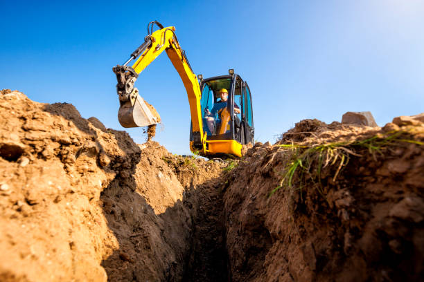 istock Excavator digs the foundation for the house 1030907924