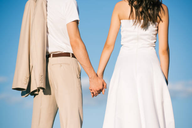istock back view of wedding couple holding hands 1030908696