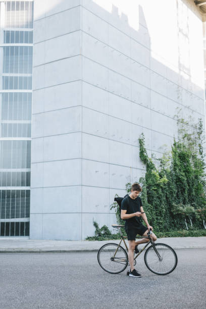 istock Bicycle messenger checking directions on smartphone 1030912654