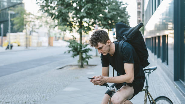 istock Bicycle messenger checking directions on smartphone. 1030912728