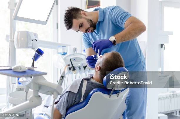 Dentis Giving Anesthesia To Patient Stock Photo - Download Image Now - Dentist, Males, Patient