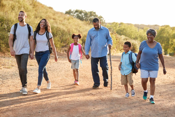 istock Multi Generation Family Wearing Backpacks Hiking In Countryside Together 1030913708