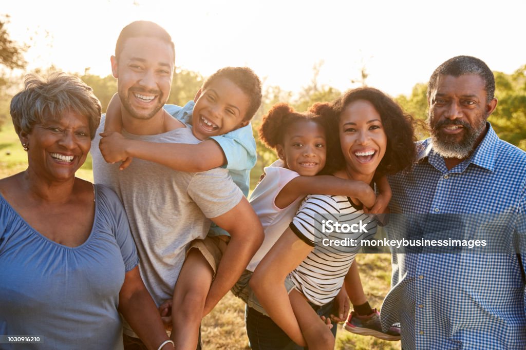 Portrait Of Multi Generation Family Enjoying Walk In Park Together Family Stock Photo