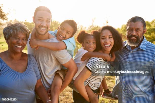 Portrait Of Multi Generation Family Enjoying Walk In Park Together Stock Photo - Download Image Now