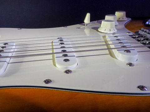 Close-up of electric classical bass guitar isolated white on background.