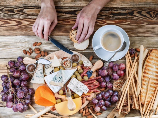 istock Female hands spread cheese on toast. Top view. Breakfast concept 1030920396