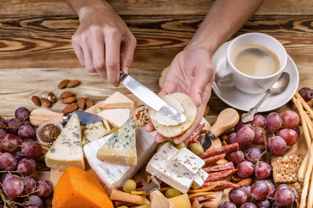 istock Female hands spread cheese on toast. Top view. Breakfast concept 1030920440