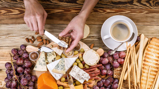 istock Female hands spread cheese on toast. Top view. Breakfast concept 1030920488