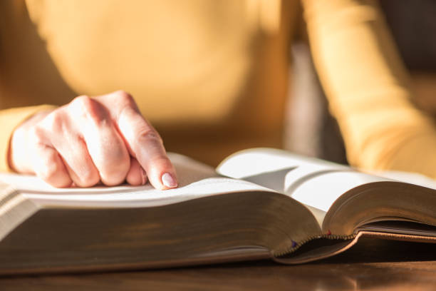 istock Woman reading the bible, hard light 1030920724