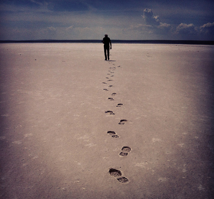 Walk Alone Man And Footprints In Lake Tuz, Turkey.
